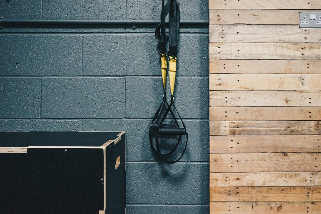 a pair of trx trainers hanging on a wall next to a box